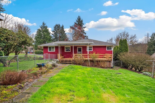 back of property with a fenced backyard and a yard