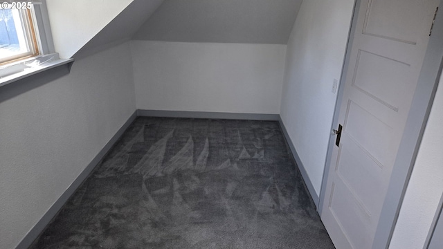 708 W Fourth Plain Blvd, Vancouver, WA 98660 - additional living space with dark carpet, lofted ceiling, and baseboards
