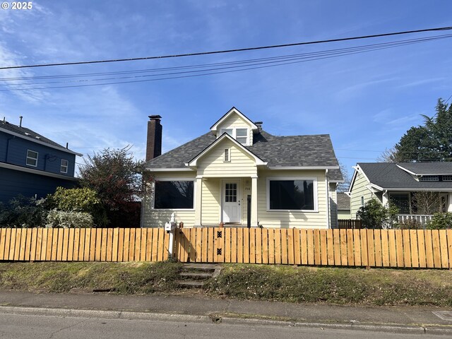 708 W Fourth Plain Blvd, Vancouver, WA 98660 - view of front of home featuring a chimney, roof with shingles, and a fenced front yard