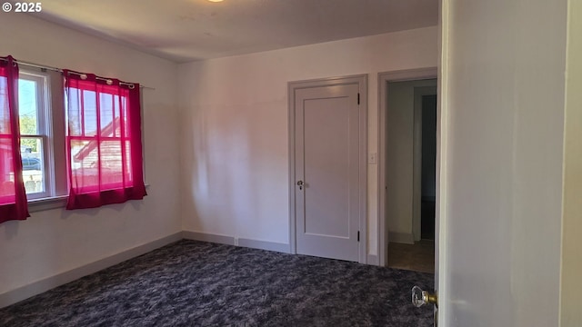 708 W Fourth Plain Blvd, Vancouver, WA 98660 - spare room with dark colored carpet, a healthy amount of sunlight, and baseboards