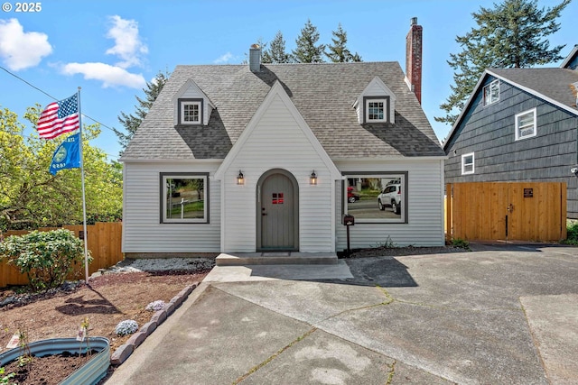 view of front of home featuring fence and a shingled roof