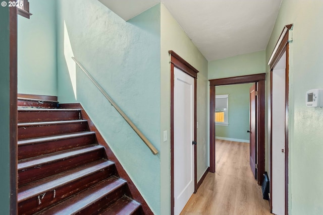 stairs featuring baseboards and wood finished floors