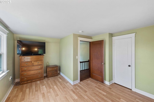 unfurnished bedroom with baseboards and light wood finished floors
