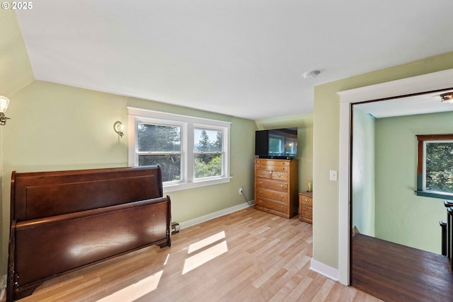 interior space with baseboards, light wood-style flooring, and a wealth of natural light