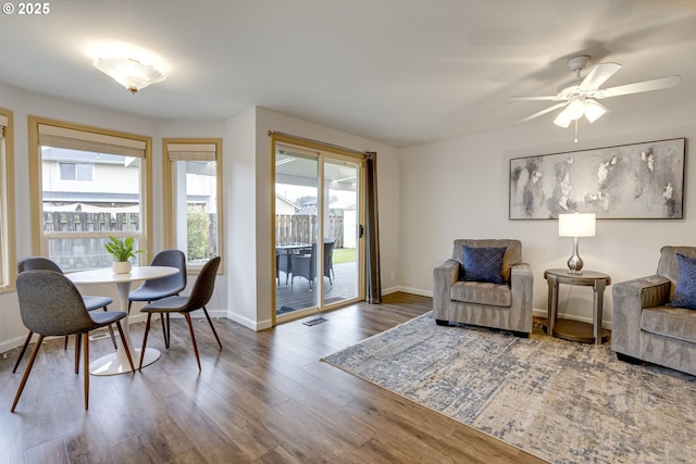 living room featuring wood-type flooring and ceiling fan