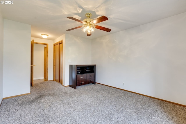 spare room with ceiling fan and carpet