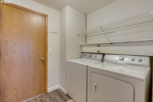 laundry room with dark hardwood / wood-style floors and washer and dryer