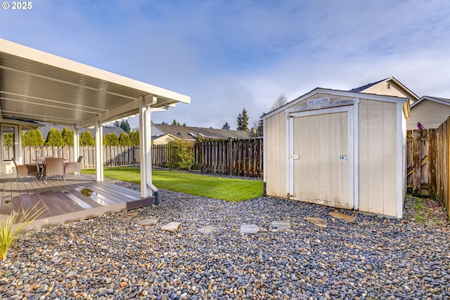 view of yard featuring a shed and a wooden deck