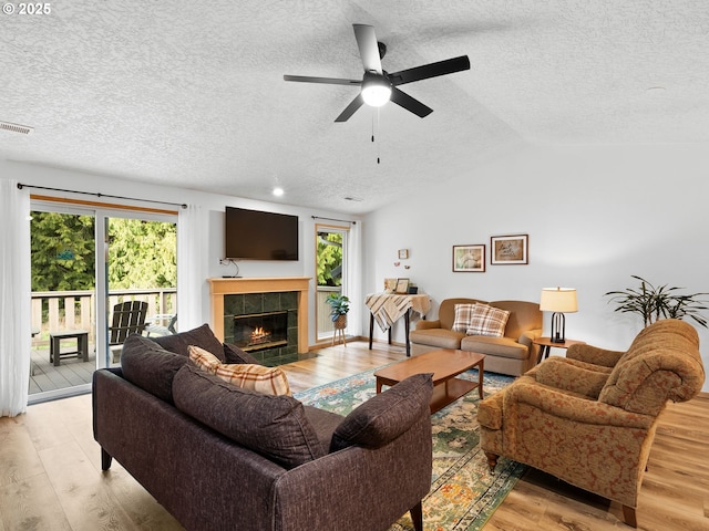 living area with plenty of natural light, light wood-style flooring, and vaulted ceiling