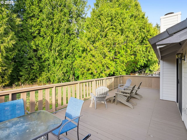 wooden deck featuring outdoor dining space