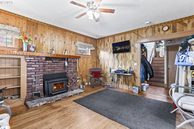 3235 NE 65th Ave, Portland, OR 97213 - workout area featuring wood walls, a brick fireplace, a ceiling fan, healthy amount of natural light, and wood finished floors