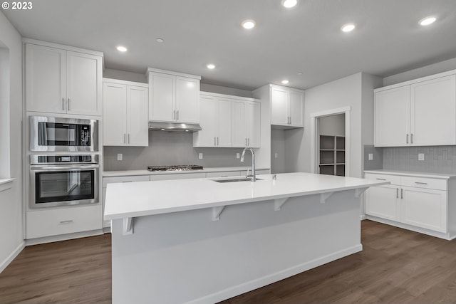 2604 S 8th Way, Ridgefield, WA 98642 - kitchen with appliances with stainless steel finishes, under cabinet range hood, dark wood-type flooring, decorative backsplash, and recessed lighting