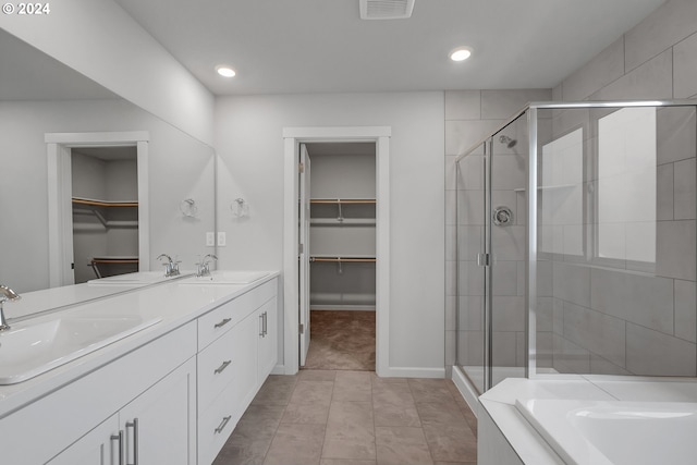 2604 S 8th Way, Ridgefield, WA 98642 - bathroom featuring a walk in closet, a stall shower, double vanity, a bath, and recessed lighting