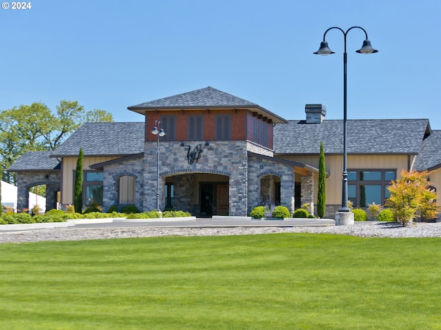 2604 S 8th Way, Ridgefield, WA 98642 - view of front of property with stone siding, a front lawn, a shingled roof, and a chimney