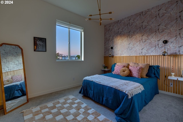 bedroom with light carpet and a chandelier