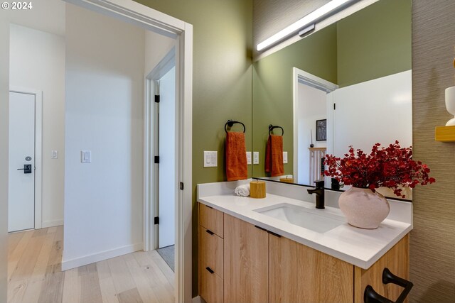 bathroom with vanity and hardwood / wood-style floors