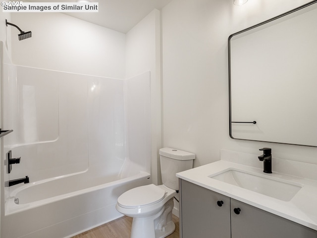bathroom featuring toilet, washtub / shower combination, vanity, and wood finished floors