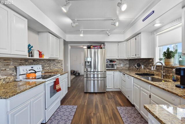 kitchen featuring white cabinetry, sink, light stone counters, and stainless steel appliances