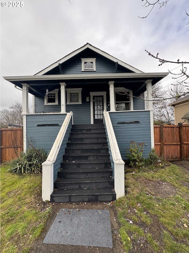 view of front of property with stairway and fence