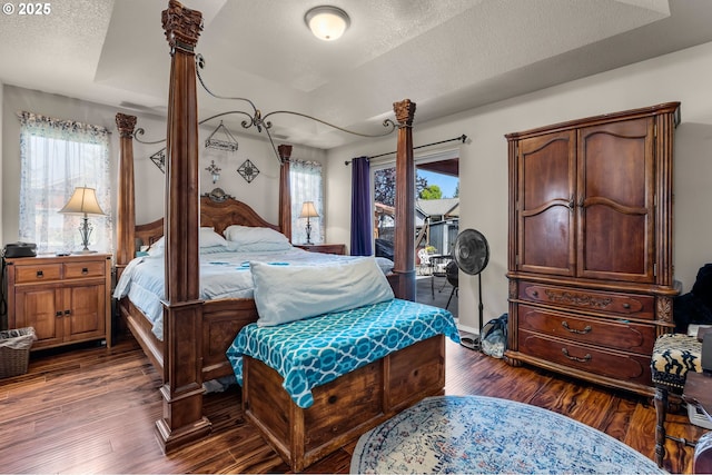 719 NE Quince Ave, Redmond, OR 97756 - bedroom with dark wood-type flooring, a textured ceiling, and access to exterior