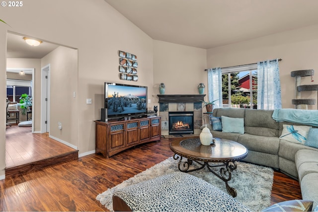 719 NE Quince Ave, Redmond, OR 97756 - living area featuring dark wood-style floors, baseboards, and a tile fireplace