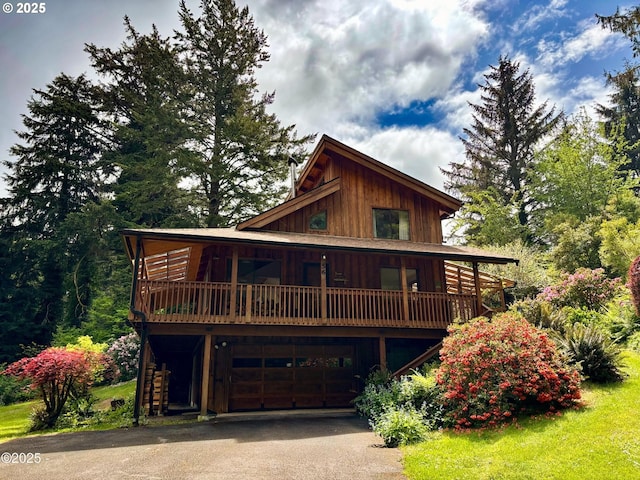 56 N Sheppard Point Rd, Waldport, OR 97394 - log home featuring driveway, an attached garage, board and batten siding, and stairway