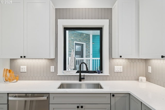 42 Washington St, Rockaway Beach, OR 97136 - kitchen featuring dishwasher, light countertops, backsplash, and gray cabinets