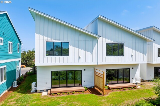 42 Washington St, Rockaway Beach, OR 97136 - back of house with board and batten siding, a deck, and a yard