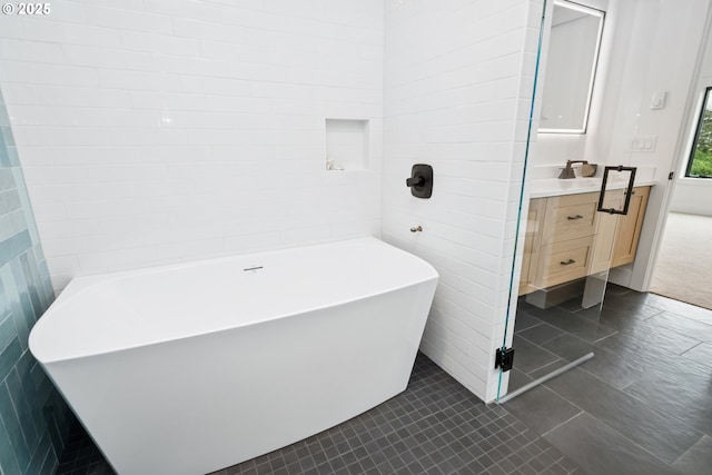 42 Washington St, Rockaway Beach, OR 97136 - bathroom featuring a freestanding tub, vanity, and tile patterned floors