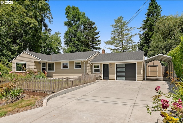 4545 SW Poplar Ln, Portland, OR 97225 - view of front of home with a shed, concrete driveway, a chimney, a garage, and a fenced front yard