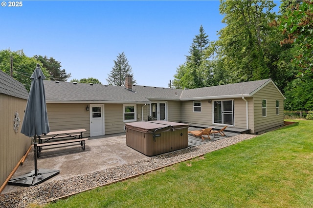 4545 SW Poplar Ln, Portland, OR 97225 - rear view of house featuring a hot tub, a patio area, a lawn, a chimney, and roof with shingles