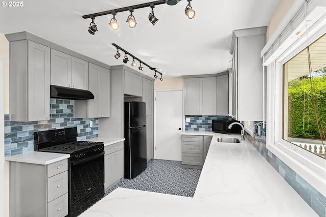 4545 SW Poplar Ln, Portland, OR 97225 - kitchen with black appliances, gray cabinets, under cabinet range hood, and light stone counters