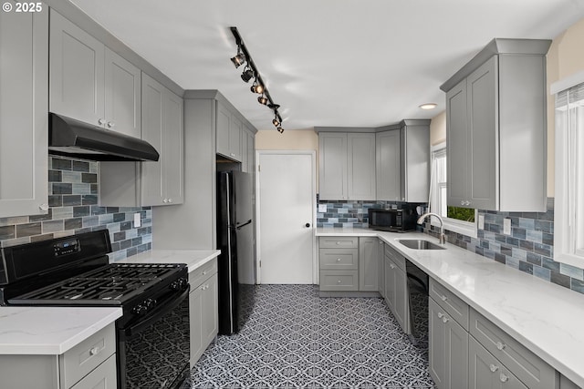 4545 SW Poplar Ln, Portland, OR 97225 - kitchen featuring black appliances, under cabinet range hood, gray cabinetry, backsplash, and light stone countertops