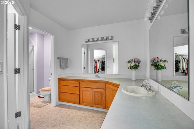 12459 SE Imperial Crest St, Happy Valley, OR 97086 - bathroom featuring a spacious closet, double vanity, toilet, and a shower stall