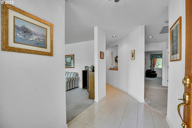 12459 SE Imperial Crest St, Happy Valley, OR 97086 - corridor with light colored carpet, baseboards, light tile patterned floors, and a textured ceiling