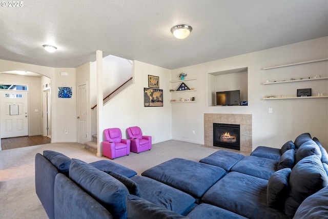 6916 NE 104th Way, Vancouver, WA 98686 - carpeted living area featuring arched walkways, baseboards, stairway, and a fireplace