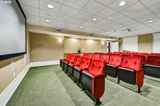 cinema room with a paneled ceiling and carpet