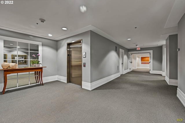 hall featuring carpet and elevator