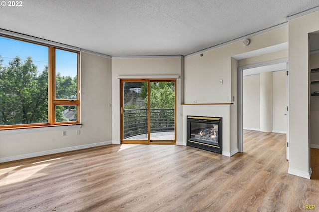 unfurnished living room featuring a textured ceiling and light wood-type flooring