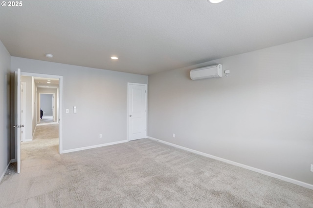 5141 SE Redberry Pl, Hillsboro, OR 97123 - unfurnished bedroom featuring an AC wall unit, light colored carpet, baseboards, and recessed lighting