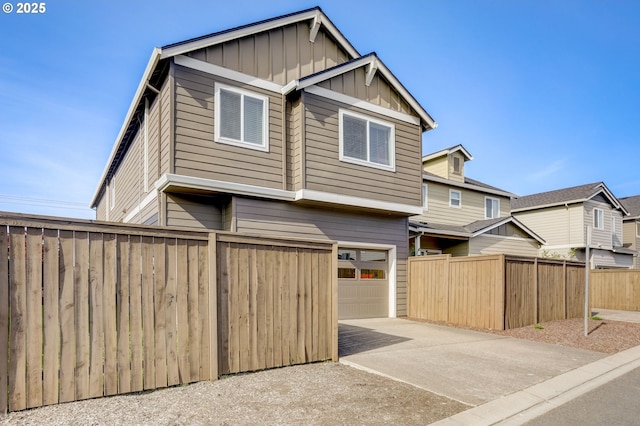 5141 SE Redberry Pl, Hillsboro, OR 97123 - view of front of home with an attached garage, board and batten siding, concrete driveway, and fence