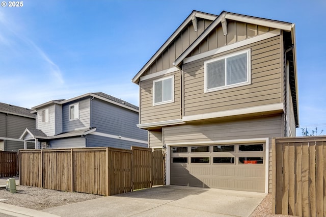 5141 SE Redberry Pl, Hillsboro, OR 97123 - view of front of house featuring board and batten siding, an attached garage, fence, and concrete driveway