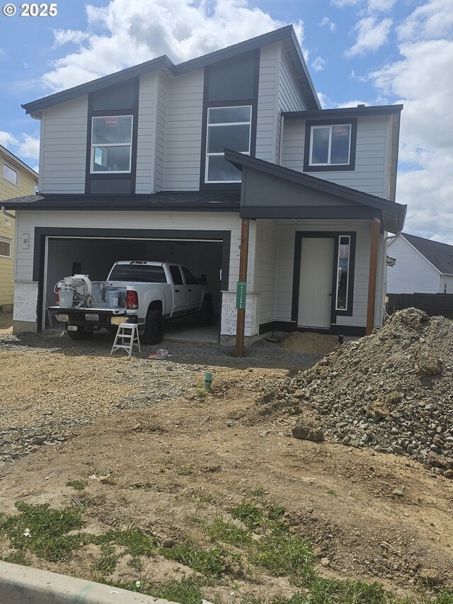 3831 S Arwana Ln, Ridgefield, WA 98642 - view of front of property with an attached garage and dirt driveway