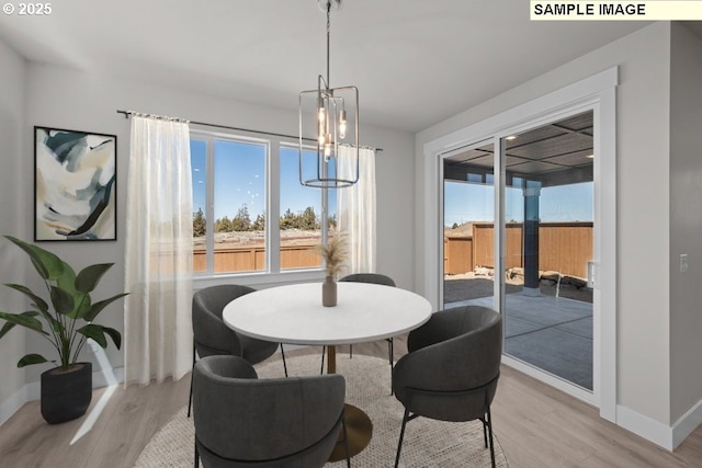 3831 S Arwana Ln, Ridgefield, WA 98642 - dining area featuring baseboards, a notable chandelier, and light wood-type flooring