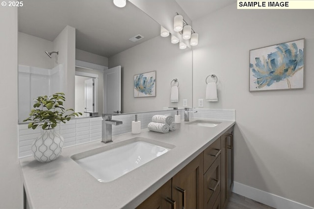 3831 S Arwana Ln, Ridgefield, WA 98642 - bathroom featuring double vanity, visible vents, a sink, and tasteful backsplash