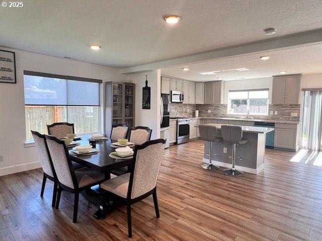 17095 SE Manley St, Portland, OR 97236 - dining space with wood finished floors, recessed lighting, and baseboards