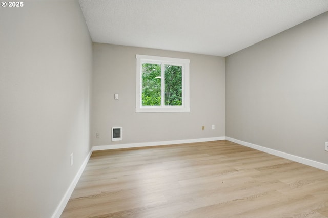 12620 NW Barnes Rd Unit 4, Portland, OR 97229 - unfurnished room featuring light wood finished floors, baseboards, and heating unit
