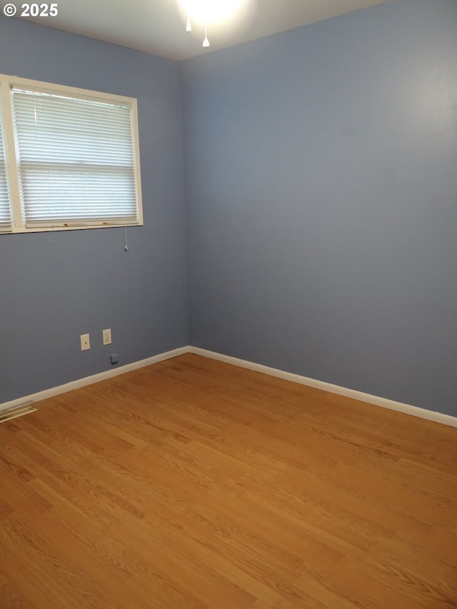 spare room featuring light hardwood / wood-style flooring