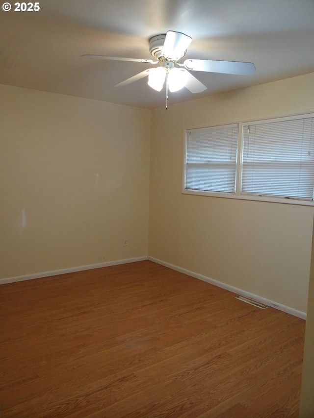 spare room featuring ceiling fan and wood-type flooring