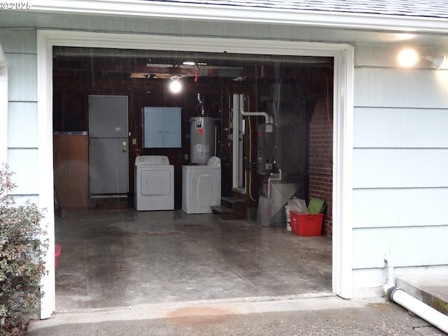 garage with separate washer and dryer and water heater